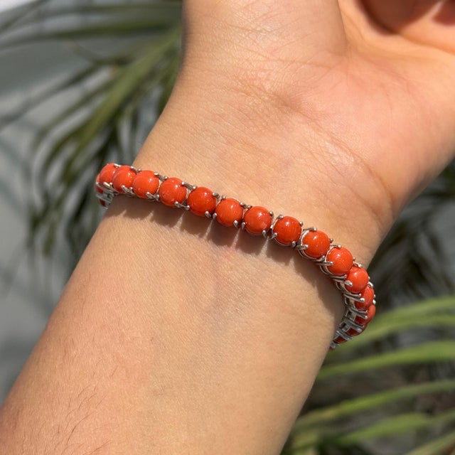 Add a bold touch of color to your jewelry collection with this elegant Carat&Her tennis bracelet, featuring 25.7 carats of...