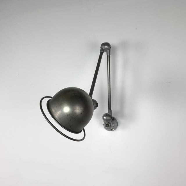 Beautiful original stripped and polished Jielde two arm wall light. Designed by the French engineer, Jean-Louis Domecq, in...