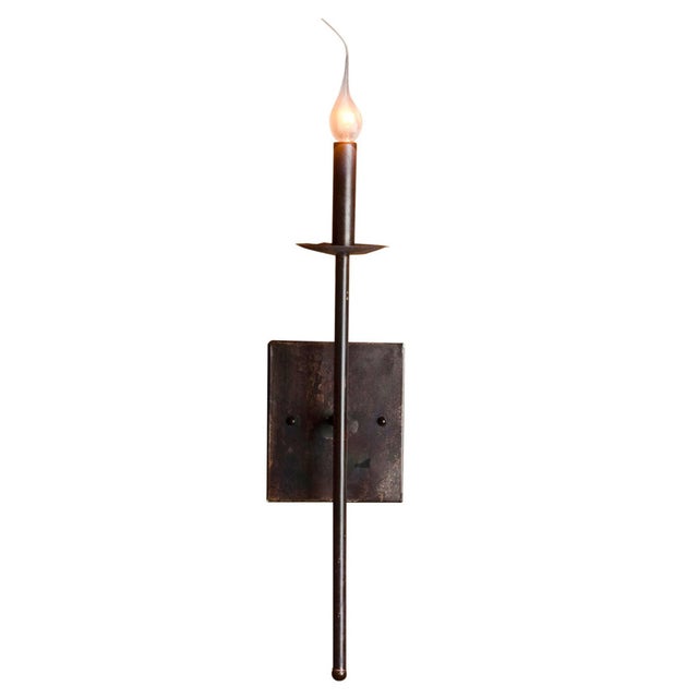 A 24-inch linear sconce in brushed steel with a five-inch projection  spare, quiet, and built to sit above a console,...