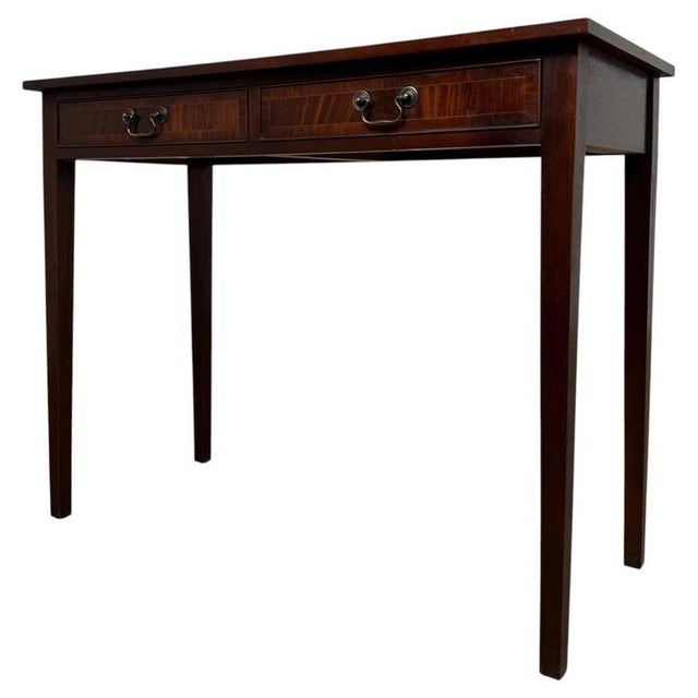 A handsome and finely crafted early 20th-century English writing table, constructed in richly figured mahogany and...