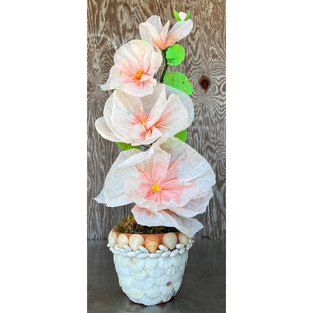 Contemporary hand-rolled paper flowers are a modern, artistic take on traditional floral arrangements. These flowers are...