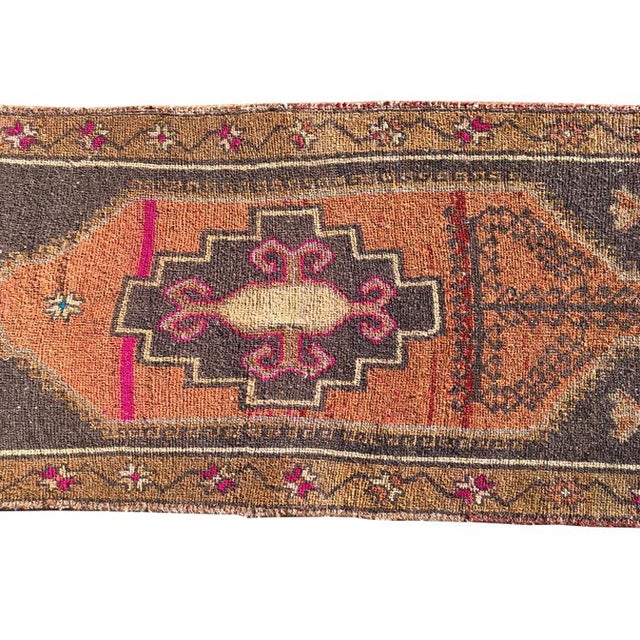 This vintage Anatolian Turkish OUSHAK RUG features hot pink, yellow, gray, white and blue on a geometric background. Hand-...