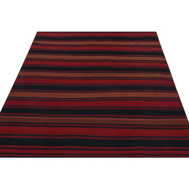 A vintage 8x9 kilim rug from Persia, handwoven in wool circa 1950-1960. Further on the Design: The simple design prefers...