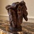 A striking metamorphic hand-carved hardwood sculpture in which seven expressive human faces come together to create the...