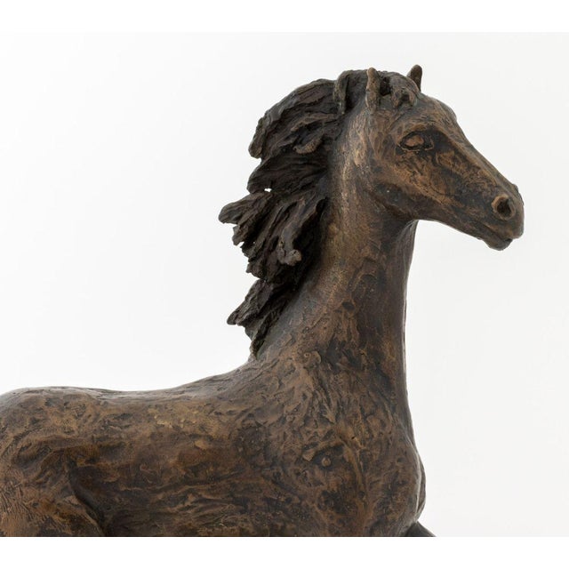 Tanya Poust (American, XX) Galloping Horse Patinated Bronze Sculpture, 1969, signed and dated "Tanya Poust 69" to base,...