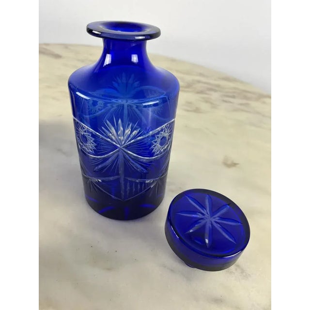 Bottle set with six lead crystal glasses, red color. The bottle has its cap, always ijn glass. All the pieces are engraved...