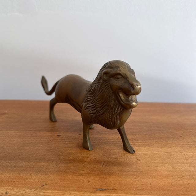 Solid brass lion figurine, with a thick mane and roaring jaw. Circa 1980s with a rich patina. Please see condition details...