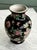 Vintage chinese porcelain vase featuring a famille noire style, characterized by a black ground decorated with colorful...
