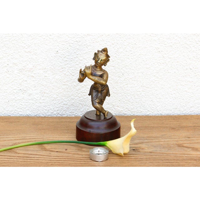 An exceptional devotional casting showcasing a fluid cross-legged stance, an engraved ritual waist sash, and a magnificent...