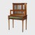 An antique French Louis XVI style vitrine, crafted circa 1920, showcases gilt wood with ormolu detailing. This display...