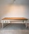 Elegant dining table combining a warm natural oak top with contrasting painted turned legs. The solid proportions,...