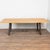 Reclaimed bowling lane wood tabletop sits upon a heavy iron base, creating a durable, industrial style dining or...