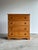 This vintage four-drawer chest features sweeping wood grain, rounded wooden pulls, and a beautifully scalloped apron that...