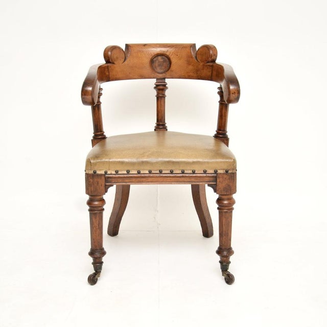A superb antique Victorian Gothic revival solid oak desk chair, made in England and dating from around the 1870-1880...