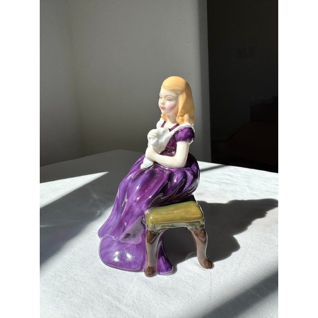 The Royal Doulton Figurine "Affection" HN 2236 (Rose) is a timeless study in grace and sentiment. Beautifully modeled in...