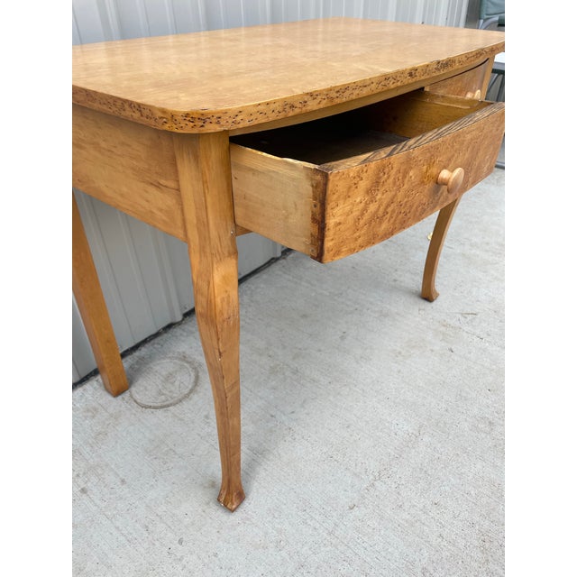 This piece is an antique bird eye maple writing table or vanity desk likely dating back to the late Victorian or Queen...
