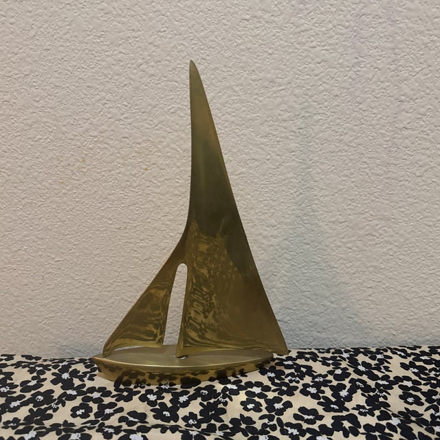 This vintage item is a Mid-Century Modern solid brass sailboat, a popular decorative piece from the 1960s and 70s often...