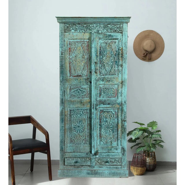 Bohemian Vintage Armoire Artistic Carved Farmhouse Blue Cabinet. With two spacious doors, four shelves, and two drawers,...
