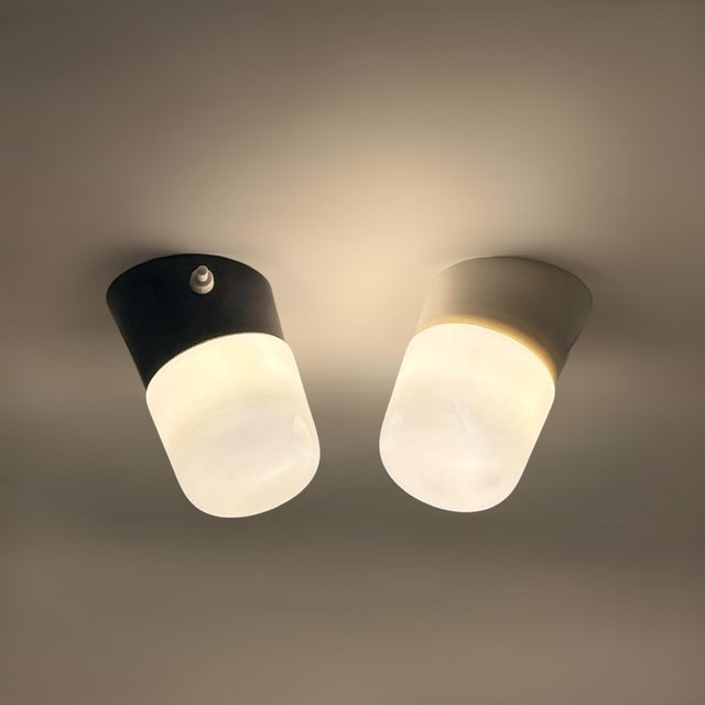 Pair of Italian opaline glass wall lights produced circa 1970 and preserved in remarkable new old stock condition. These...
