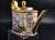 An exceptional French porcelain oval teapot, of the théière « Ovale » or « Bielle » form, hand-painted and gilded at the...