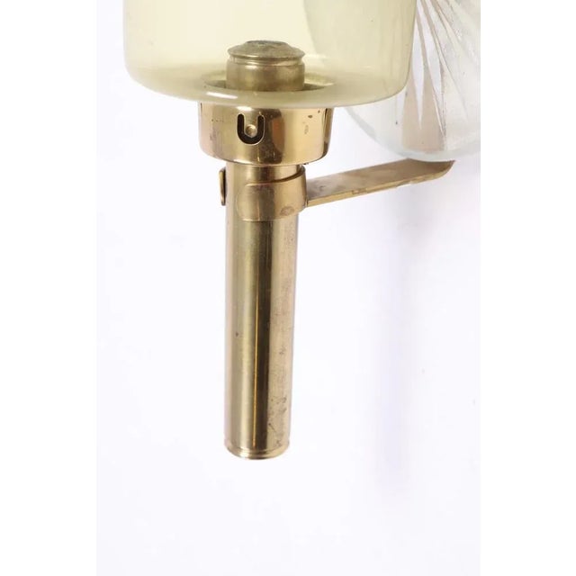 Set of four wall candelabras in brass and glass. Made in Sweden 1950s.