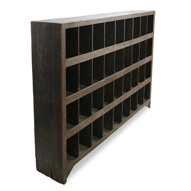 This generous compartments shelf displays an industrial vintage aesthetic, with its solid wood structure which highlights...