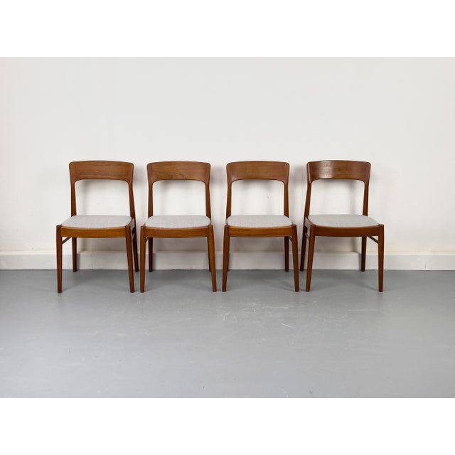 Elegant dining chairs from Denmark, crafted from warm teak. The clean lines, tapered legs, and gently curved backrest lend...