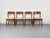 Elegant dining chairs from Denmark, crafted from warm teak. The clean lines, tapered legs, and gently curved backrest lend...