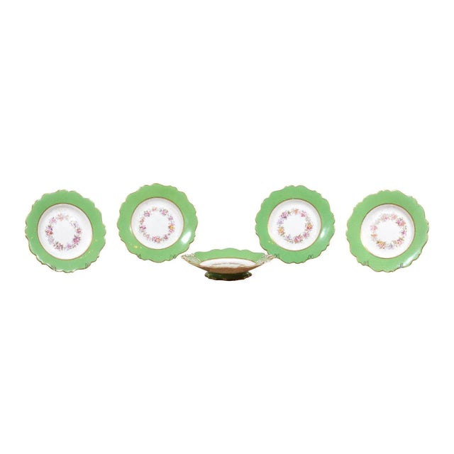 A Ridgway porcelain hand painted compote from the 19th century, with green rim and floral decor. Born in England during...