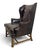 Handsome vintage wingback chair by Baker Furniture, upholstered throughout in richly patinated dark brown leather. The...