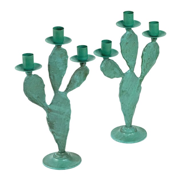 Vintage 1990s pair of sculptural metal cactus candelabras in a turquoise finish. Each piece is formed as a prickly pear...