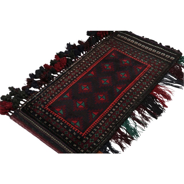 Hand knotted in wool, this 2x4 Baluch scatter rug represents a new line of tribal carpets in the Modern Classics...