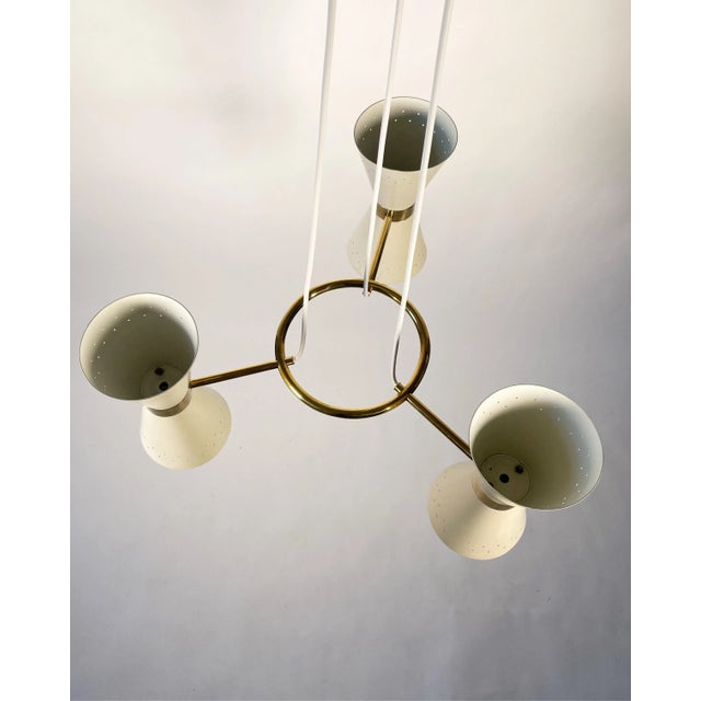 Swedish Chandelier model T19/3 by Alf Svensson for Bergboms. Three downlight metal shades supported by a brass ring. The...