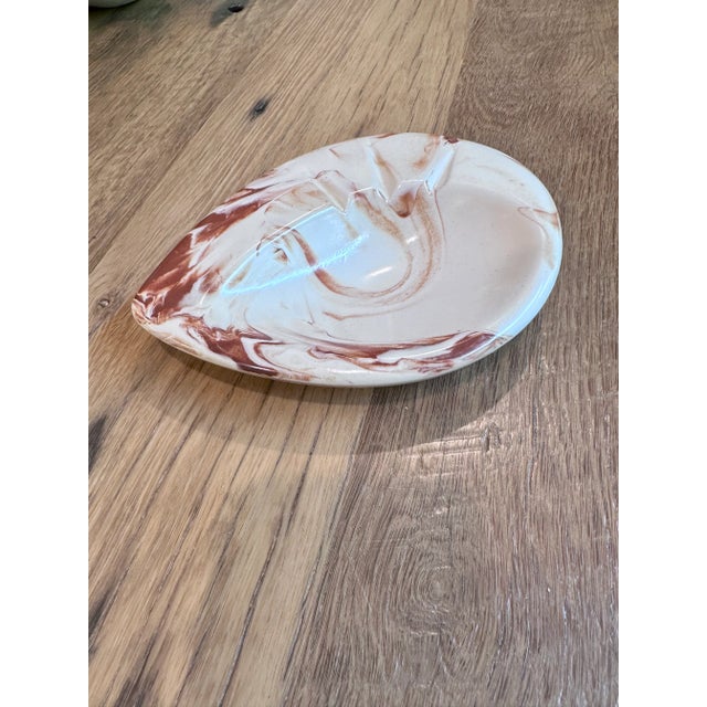Organic form for this vintage ashtray. Made from clay found in Alaska with characteristic red and cream swirl. Signed by...