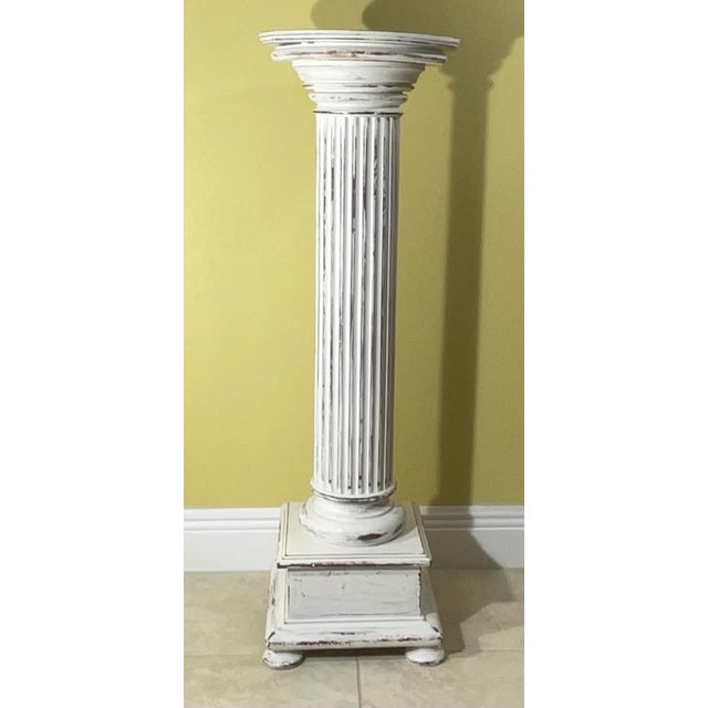Elegant pedestal made of carved walnut wood , hand painted , nice patina ,with round top and square bottom. Solid standing...