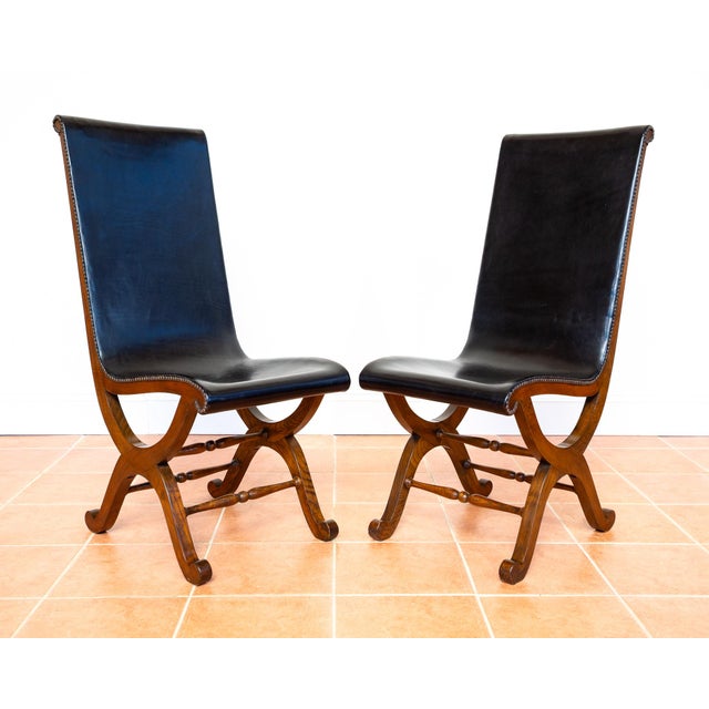 A pair of superb quality, extremely rare and very impressive spanish black leather and oak dining chairs in lovely...