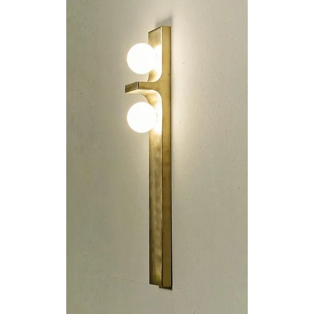Dl440 wall lamp in satin brass with two blown glass spheres by daluce dimensions: d 10,3 x 8,5 x h 65 cm. Materials: brass...
