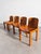 Italian dining chairs from the 1970s featuring molded plywood seats and curved backrests on a solid ash frame. The clean...