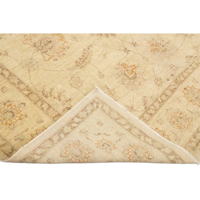 Beautiful modern Oushak hand-knotted wool rug with a beige field. This Oushak rug has brown and orange accents that...