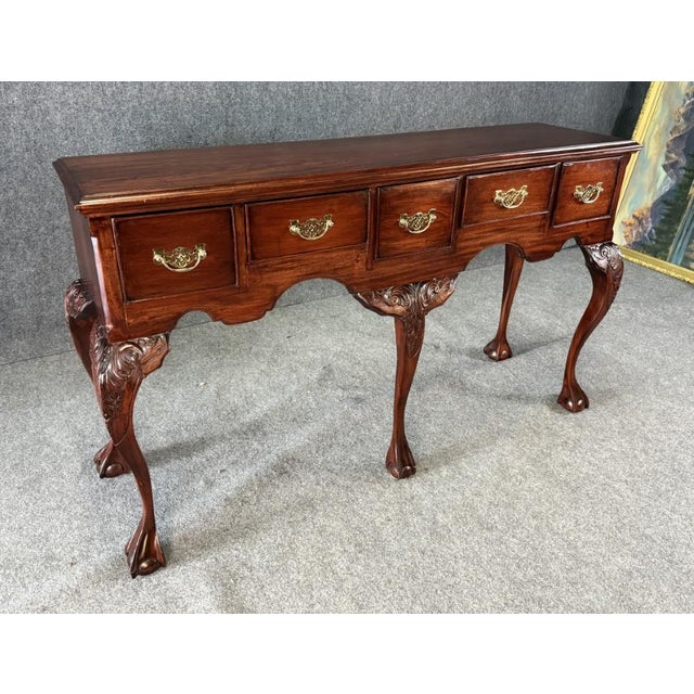 This elegant mahogany sideboard features classic Chippendale styling with carved cabriole legs, shell-carved knees, and...