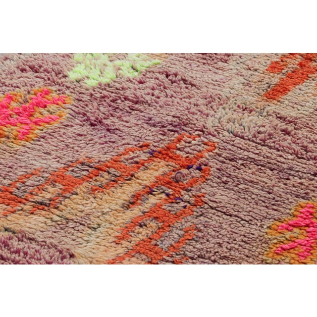 Hand-knotted in wool and originating from Morocco circa 1950-1960, this 3x9 vintage runner rug is a rare and among the...