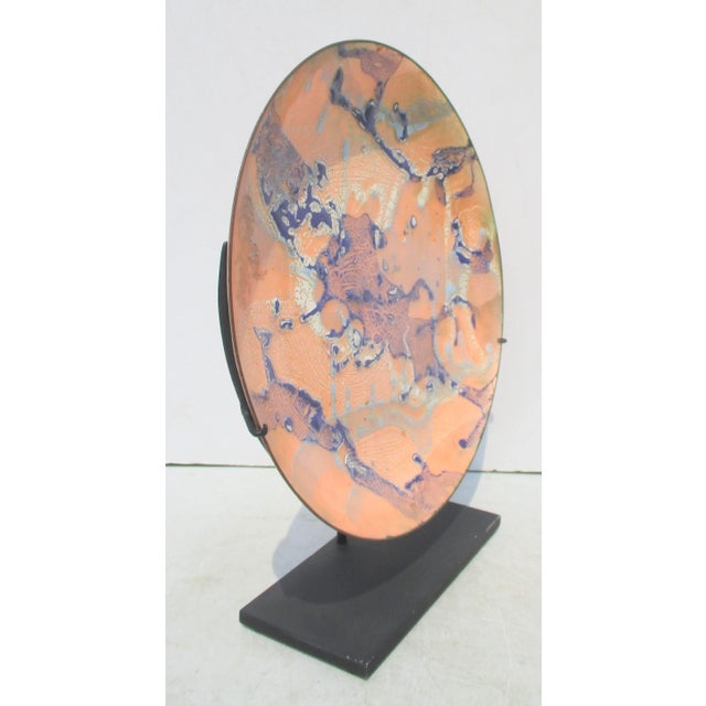 Enamel on copper platters on a steel museum mount. Signed Hazel to the reverse the copper body is thinly concealed by blue...