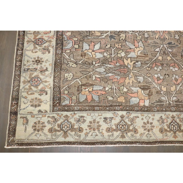 An early 20th century room size Persian Heriz in predominantly brown. Measures: 8'8'' x 11'1''.