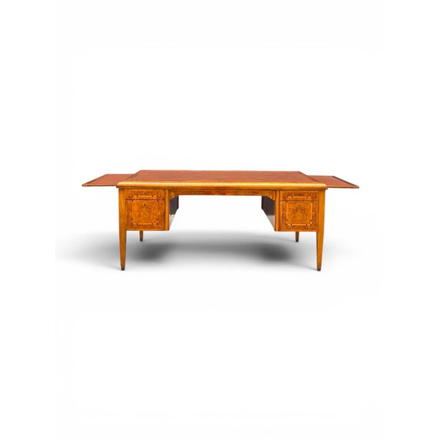 A striking French Art Deco desk dating to the 1920s, featuring clean architectural lines, a warm wood finish, and a finely...