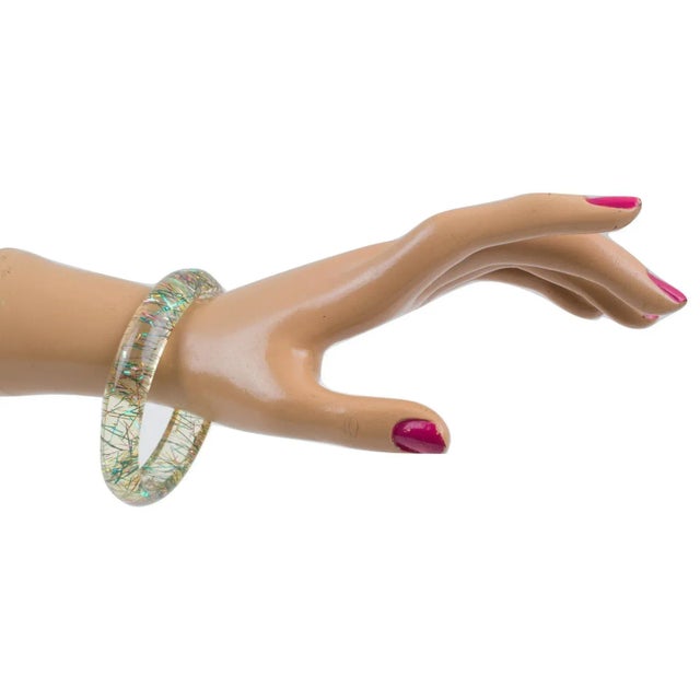 This is part of Chairish’s Costume Jewelry assortment. Lovely Lucite bracelet bangle. The bangle has a domed shape and is...