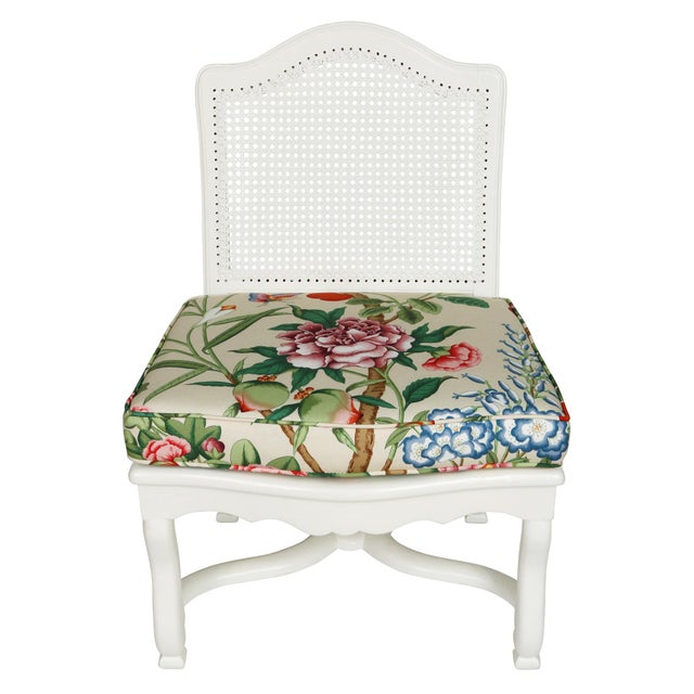 A vintage slipper chair blending classic elegance with a fresh Chinoiserie spirit. The frame is painted crisp white,...