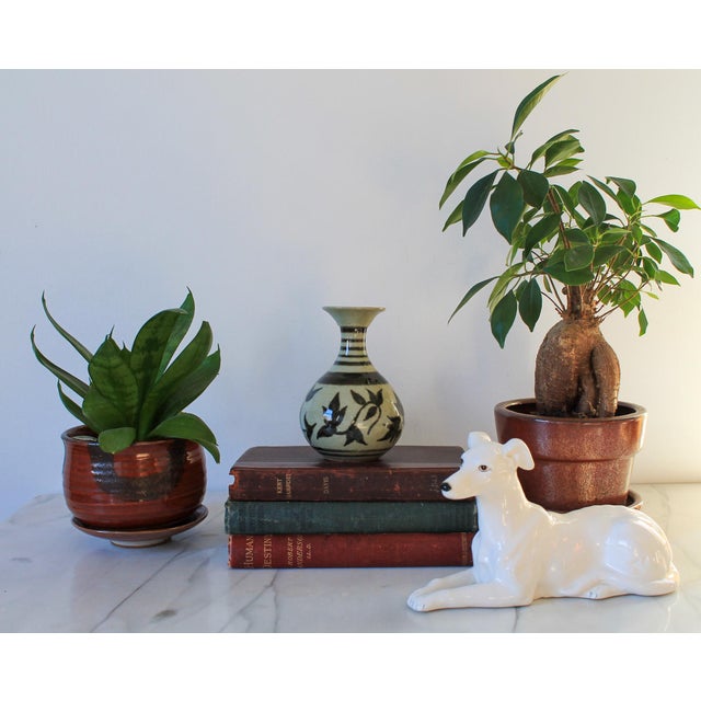 Vintage studio art pottery bud vase with strip and floral motif. Makers stamp on bottom. No chips or cracks.