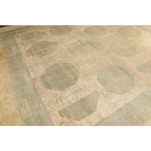 An abstract one-of-a-kind large square antique Turkish oushak 1920s rug with an abstract motif in soft green sitting on a...