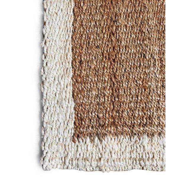 Bring natural texture and easy style to your entryway with this natural jute rug, featuring a warm, organic weave framed...