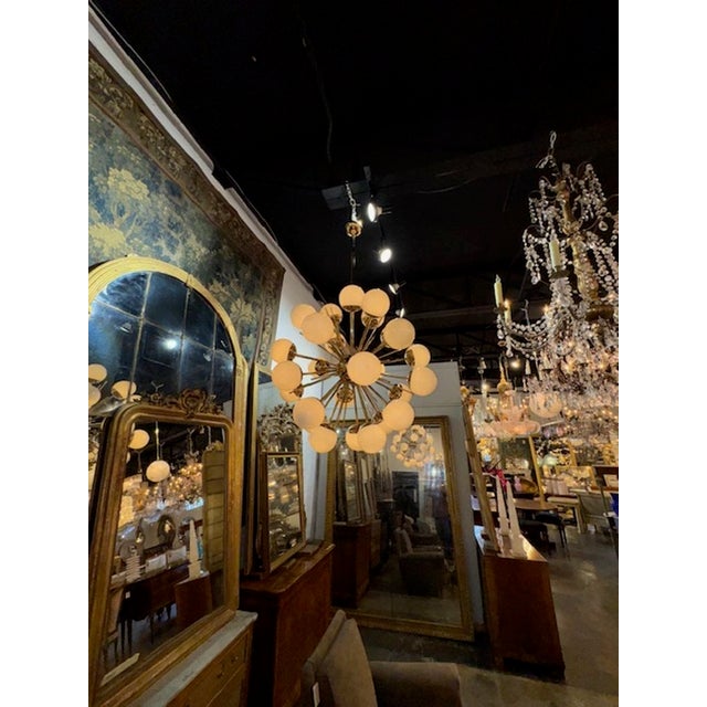 Modern Italian polished brass and pale green Murano glass Sputnik chandelier. Circa 2000. The chandelier has been...
